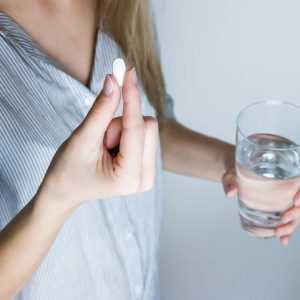 woman taking a pill