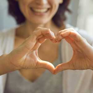 woman making a heart with her hands