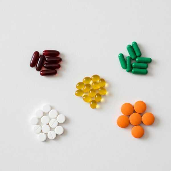 A neat arrangement of essential vitamins and minerals like iron, B12, and Vitamin D.